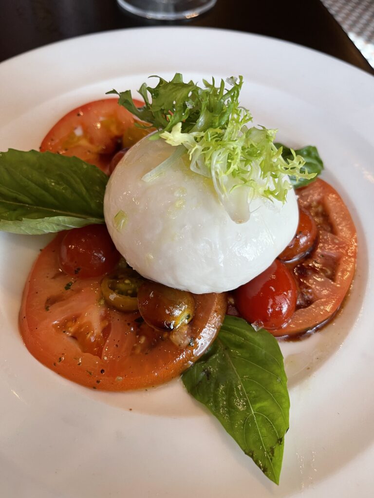 In-house made Burrata with tomatoes and basil form Trattoria al Forno.
